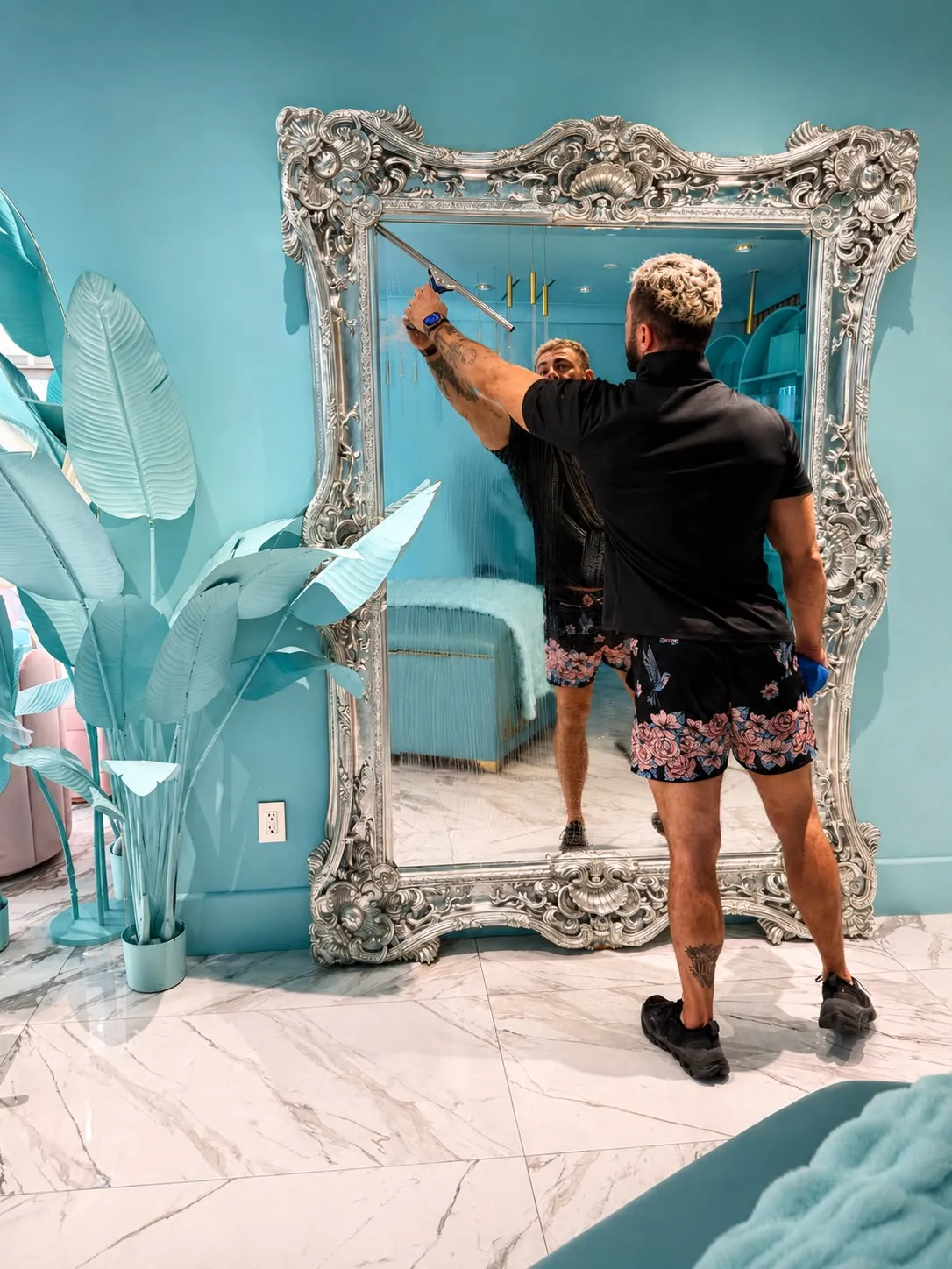 Paul squeegeeing an ornate silver-framed mirror at an Orange County beauty studio