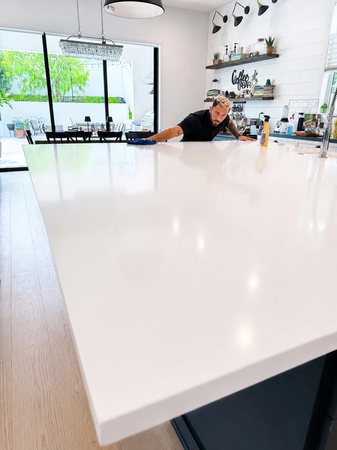 Paul polishing a white quartz kitchen island to a streak-free finish in Huntington Beach
